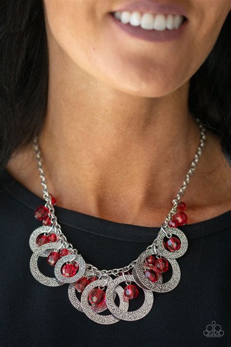 Falling from the center of the design, a trio of opulently grand teardrop beads coalesce with streams of smaller red round and teardrop beads creating a flirty fringe and dramatic allure. . Red necklace paparazzi